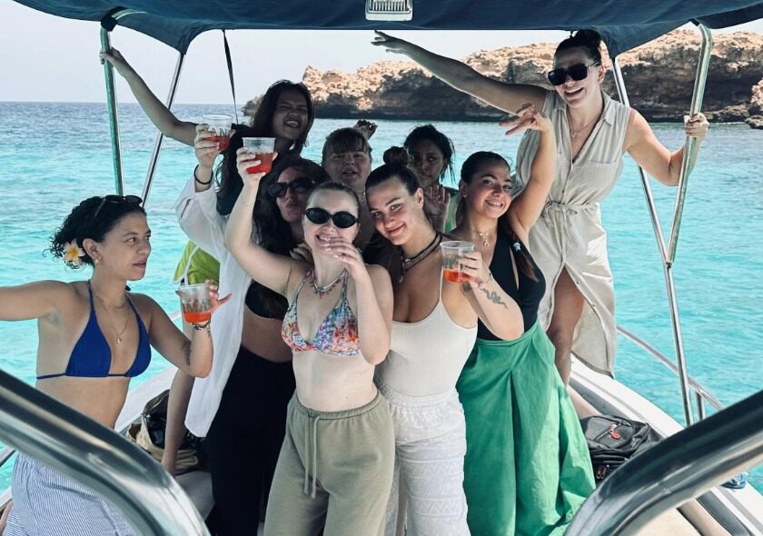 Group of girls enjoying drinks on an exclusive private boat tour at Daymaniyat Islands, Oman.