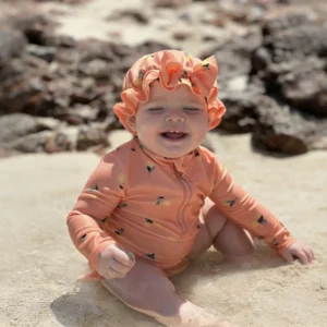 cute baby playing in sand at daymaniyat islands