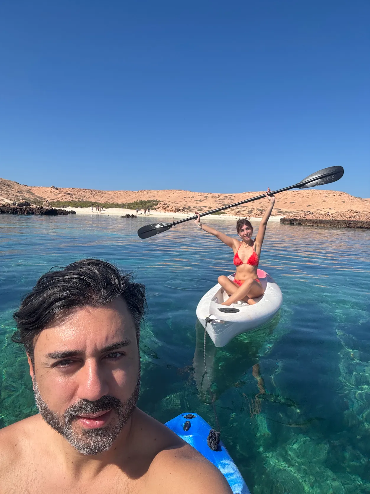 Couple kayaking in clear water at the Daymaniyat Islands